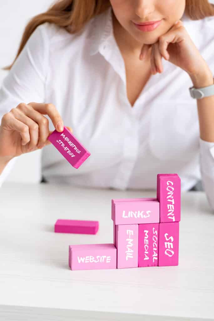 Attractive businesswomen stacking marketing blocks. Staying current with latest in digital marketing strategy